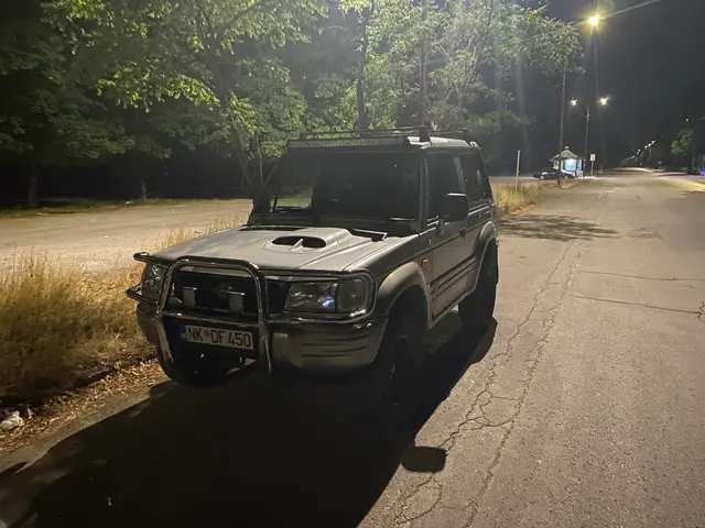 Tamni terenac parkiran na ulici noću